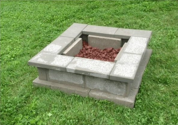small cinder block fire pit with lava rocks